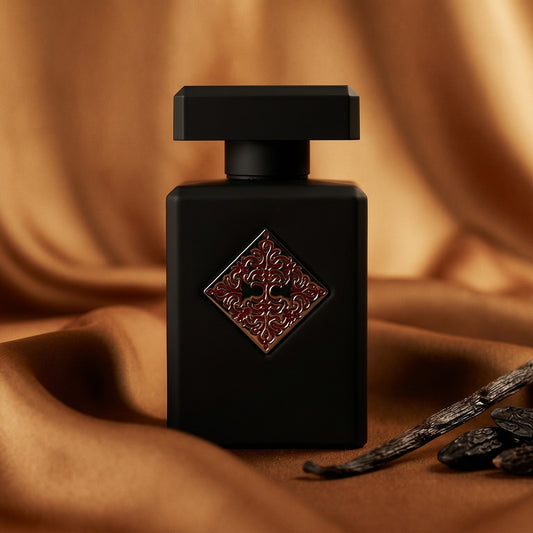 Initio Addictive Vibration EDP on warm caramel silk with a vanilla pod and tonka bean beside the bottle