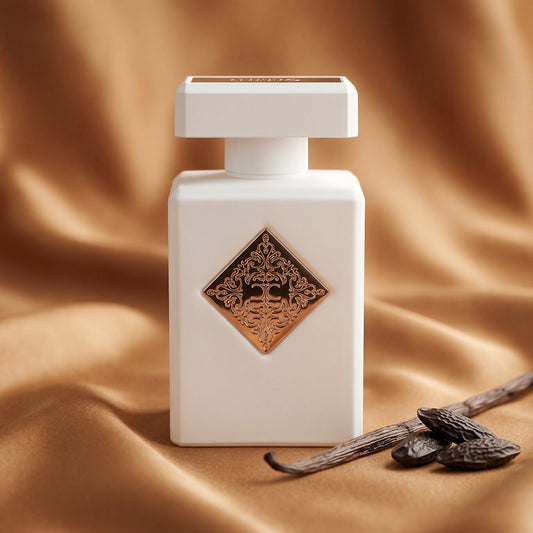 Initio Lift Me Up Extrait de Parfum on warm caramel silk with a vanilla pod and tonka bean beside the bottle