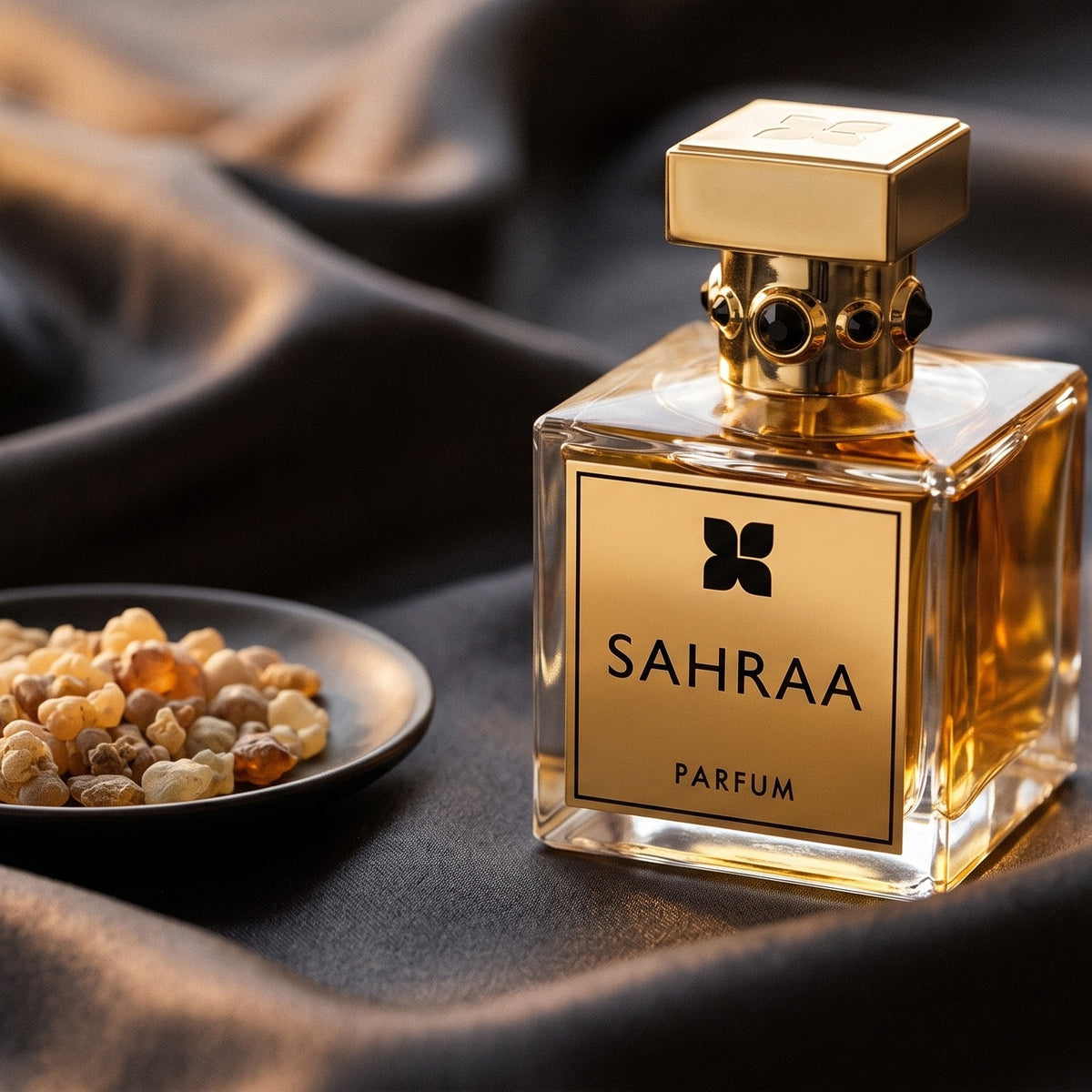 Fragrance Du Bois Sahraa Parfum EDP on charcoal silk with frankincense resin granules in a small saucer