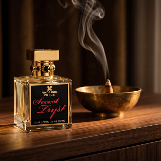 Fragrance Du Bois Secret Tryst on dark walnut console with a small brass incense bowl with smoke curling upward