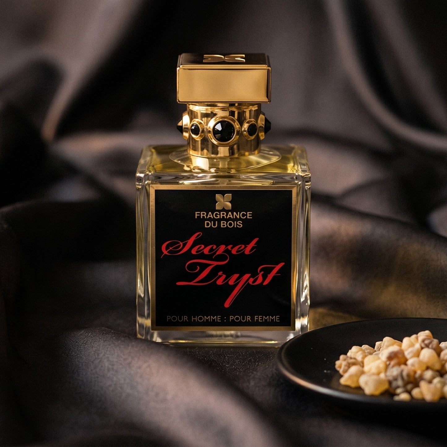 Fragrance Du Bois Secret Tryst on charcoal silk with frankincense resin granules in a small saucer