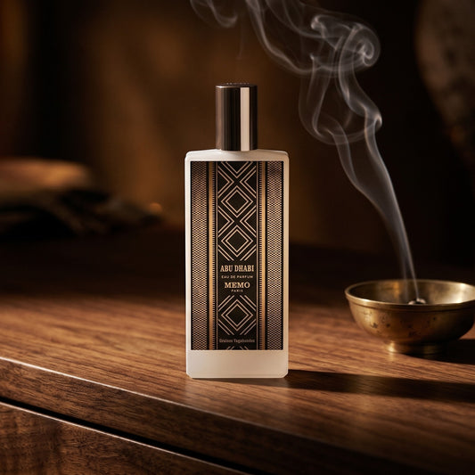 Memo Paris Abu Dhabi EDP on dark walnut console with a small brass incense bowl with smoke curling upward