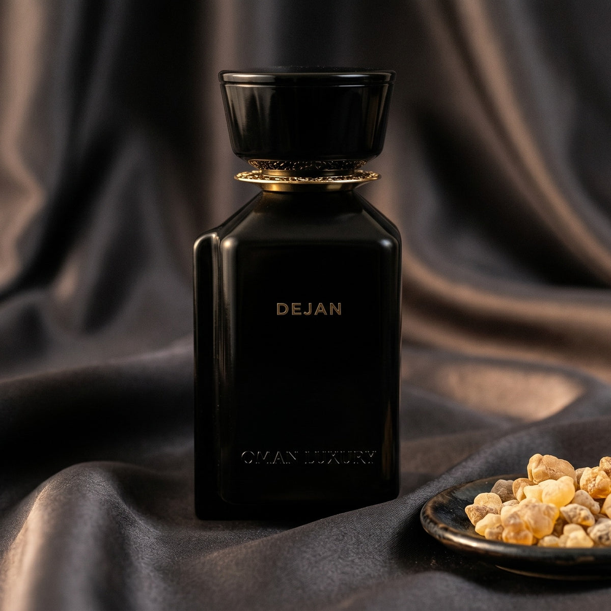 Oman Luxury Dejan EDP on charcoal silk with frankincense resin granules in a small saucer