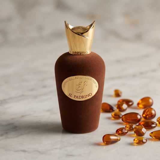 Sospiro IL Padrino EDP on pale grey marble with amber resin beads scattered to one side