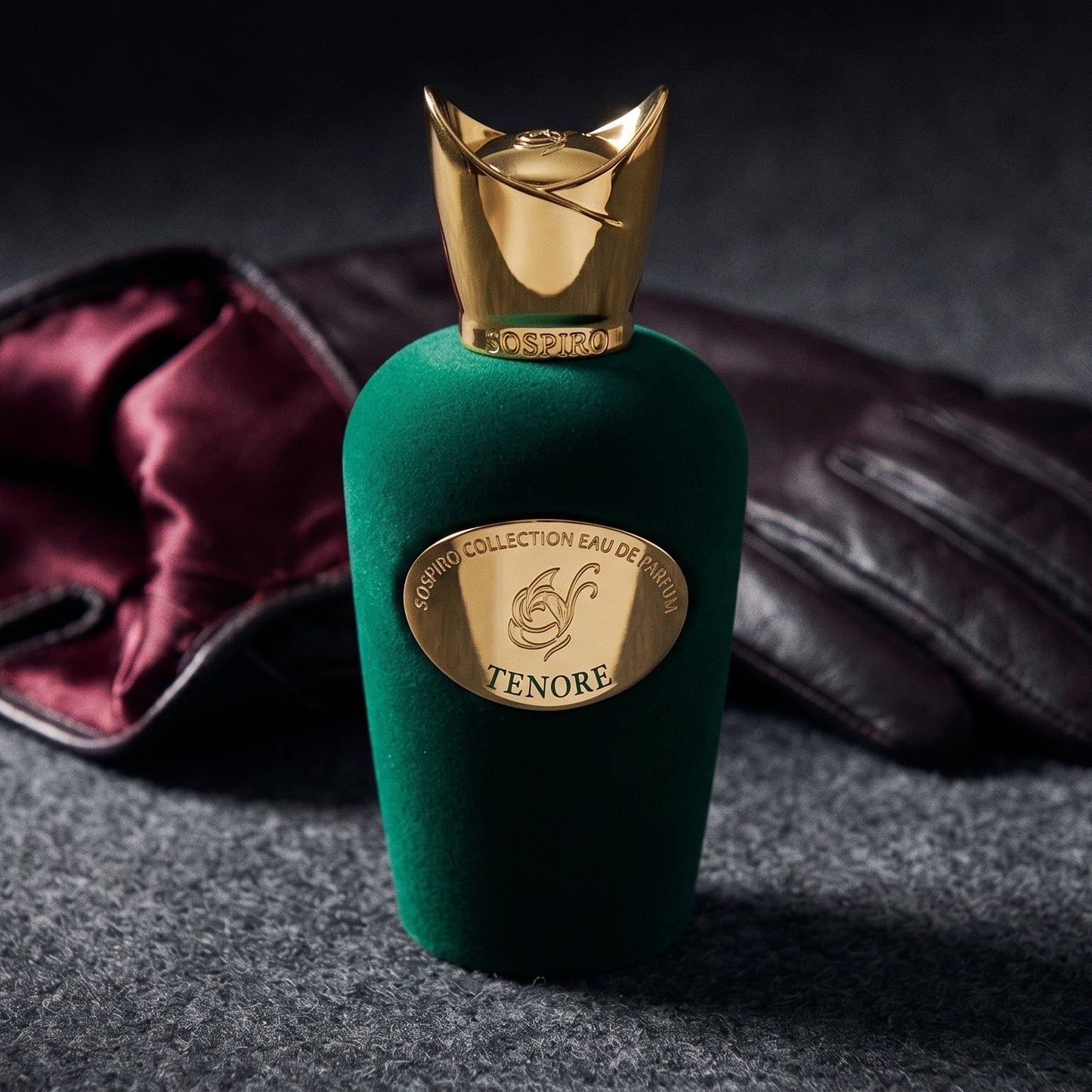 Sospiro Tenore EDP on charcoal felt with a silk-lined glove just behind the bottle