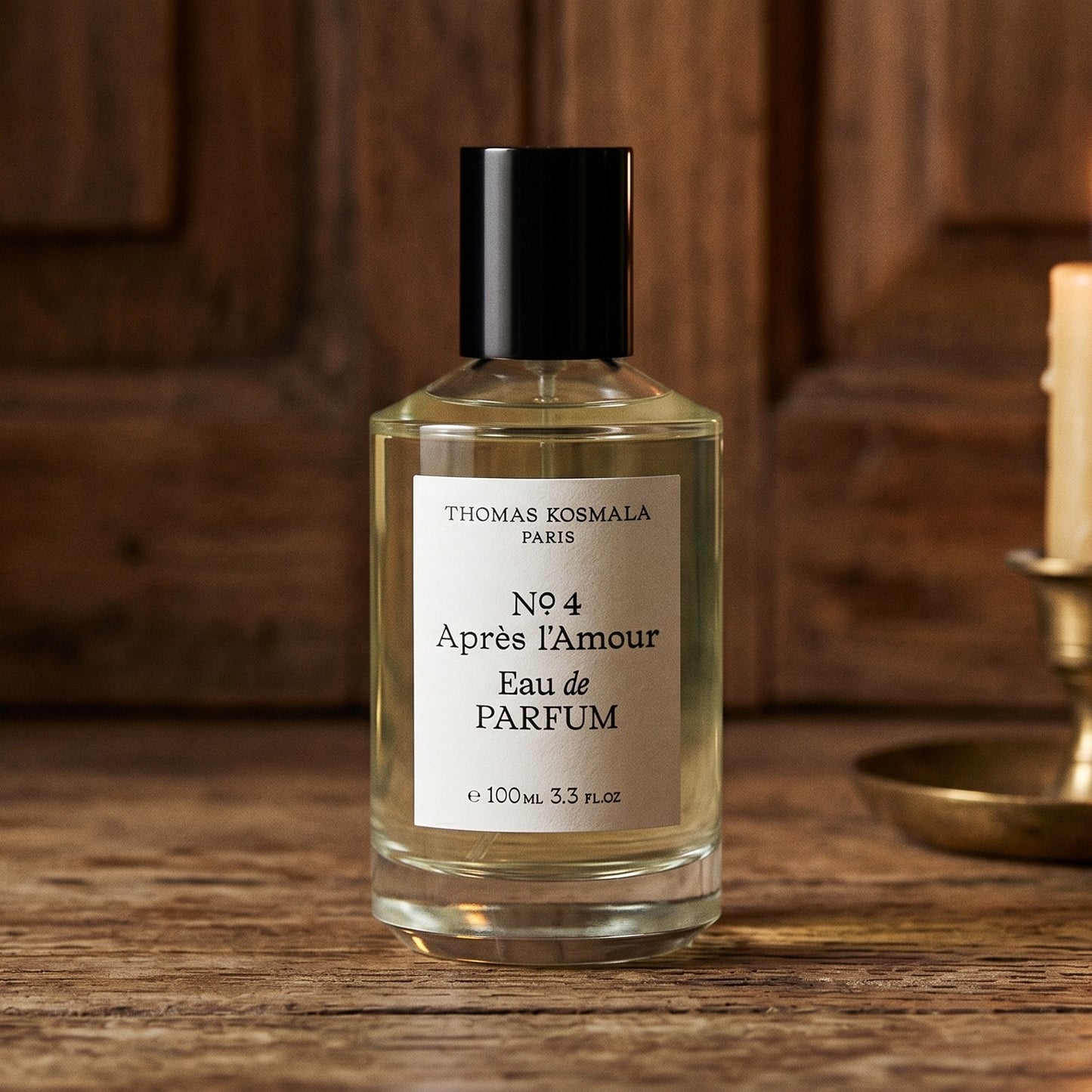Thomas Kosmala Apres LAmour No 4 EDP on aged teak with a candle burning gently to frame-right