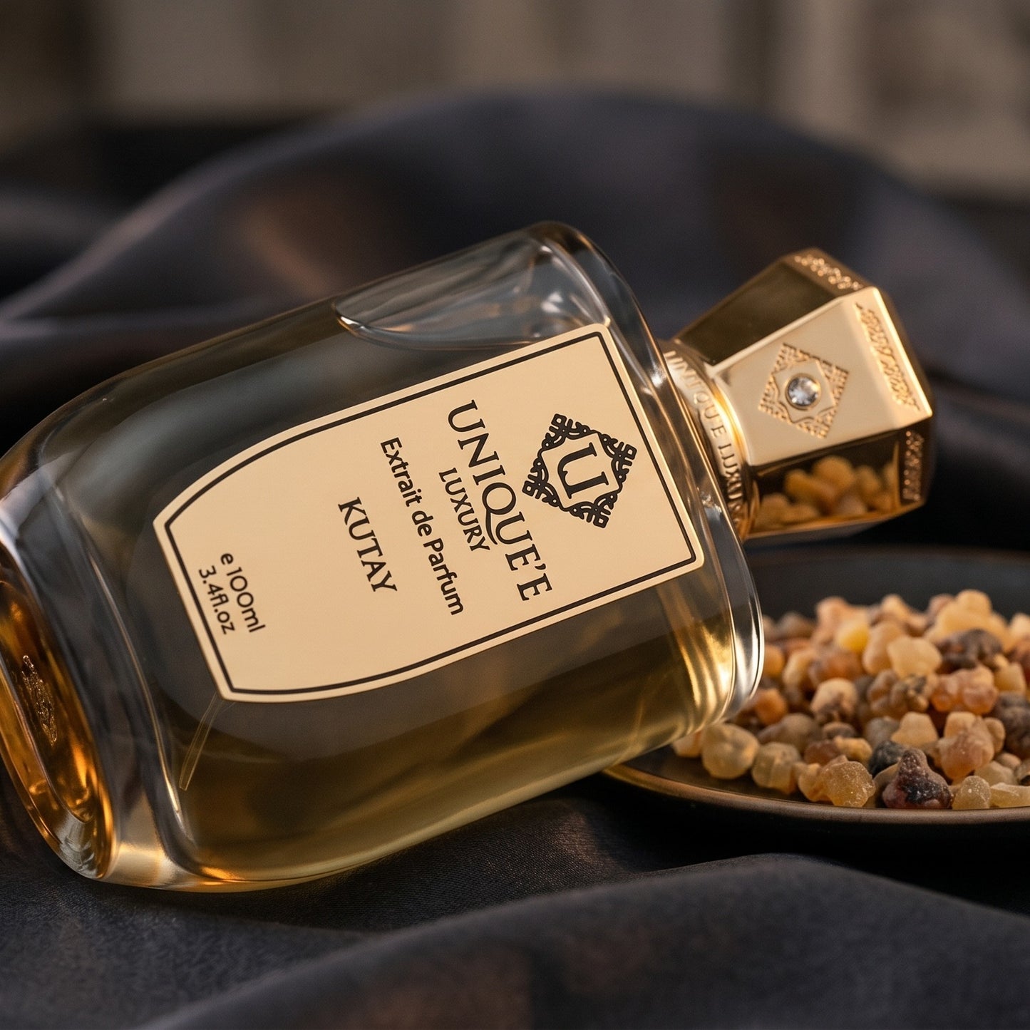 Unique Luxury Kutay Extrait on charcoal silk with frankincense resin granules in a small saucer