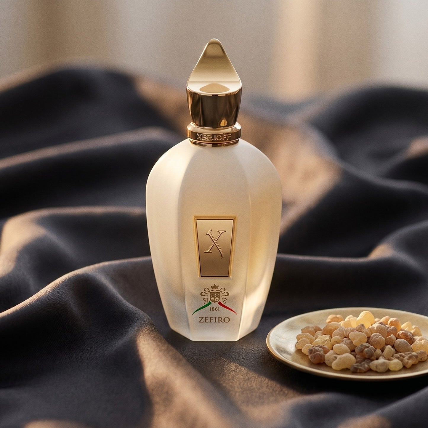 Xerjoff Zefiro EDP on charcoal silk with frankincense resin granules in a small saucer