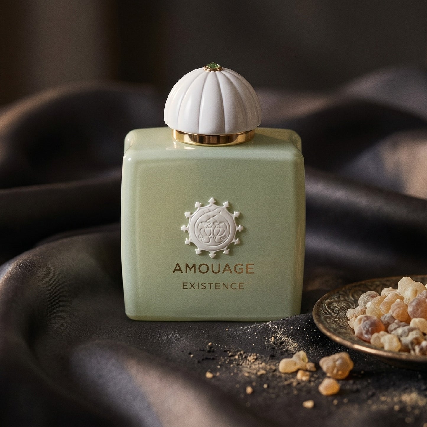 Amouage Existence EDP on onyx linen with dried rose petals and resin drops intermixed