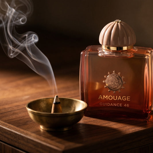 Amouage Guidance 46 EDP on black marble with a tall brass incense holder, smoke trailing diagonally