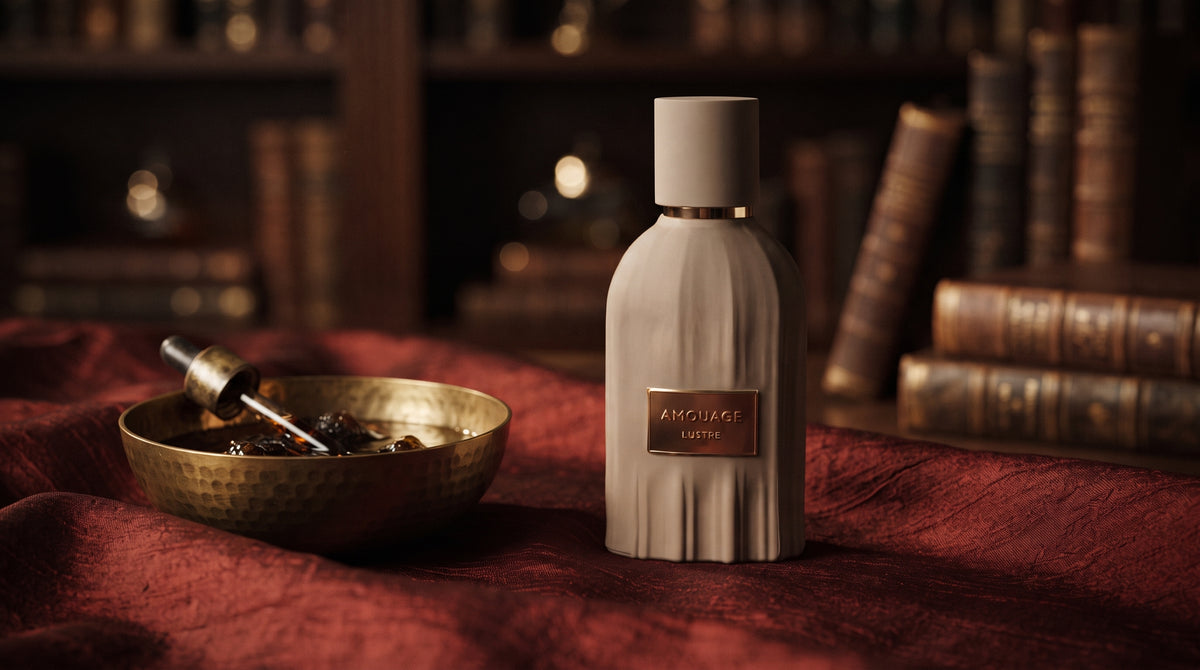 Amouage Lustre Essence de Parfum on raw silk of oxblood color with a brass bowl with ambergris tincture