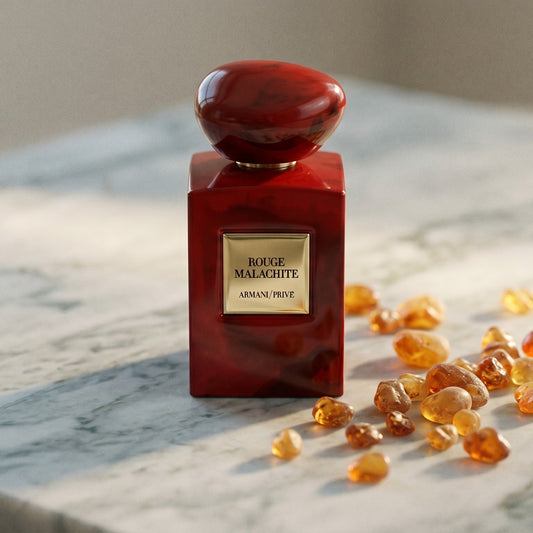 Armani/Prive Rouge Malachite on pale grey marble with amber resin beads scattered to one side