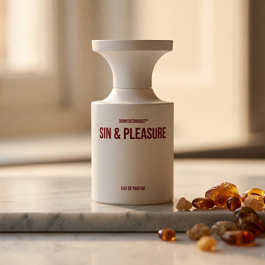Borntostandout Sin & Pleasure EDP on warm taupe marble with copal beads spilling from a small dish