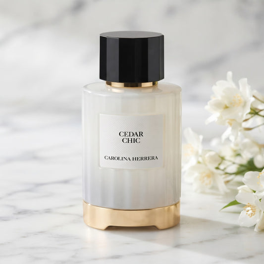 Carolina Herrera Cedar Chic EDP on white carrara marble with jasmine sprigs placed to frame-right