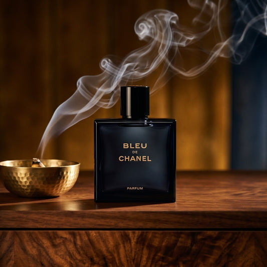Chanel Bleu de Chanel EDT on charcoal slate with a slender oud chip and drifting incense smoke