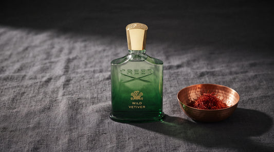 Creed Wild Vetiver EDP on charcoal linen with a small copper bowl of saffron threads