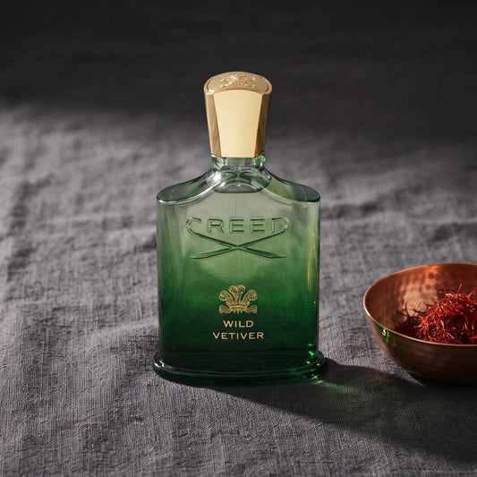 Creed Wild Vetiver EDP on charcoal linen with a small copper bowl of saffron threads