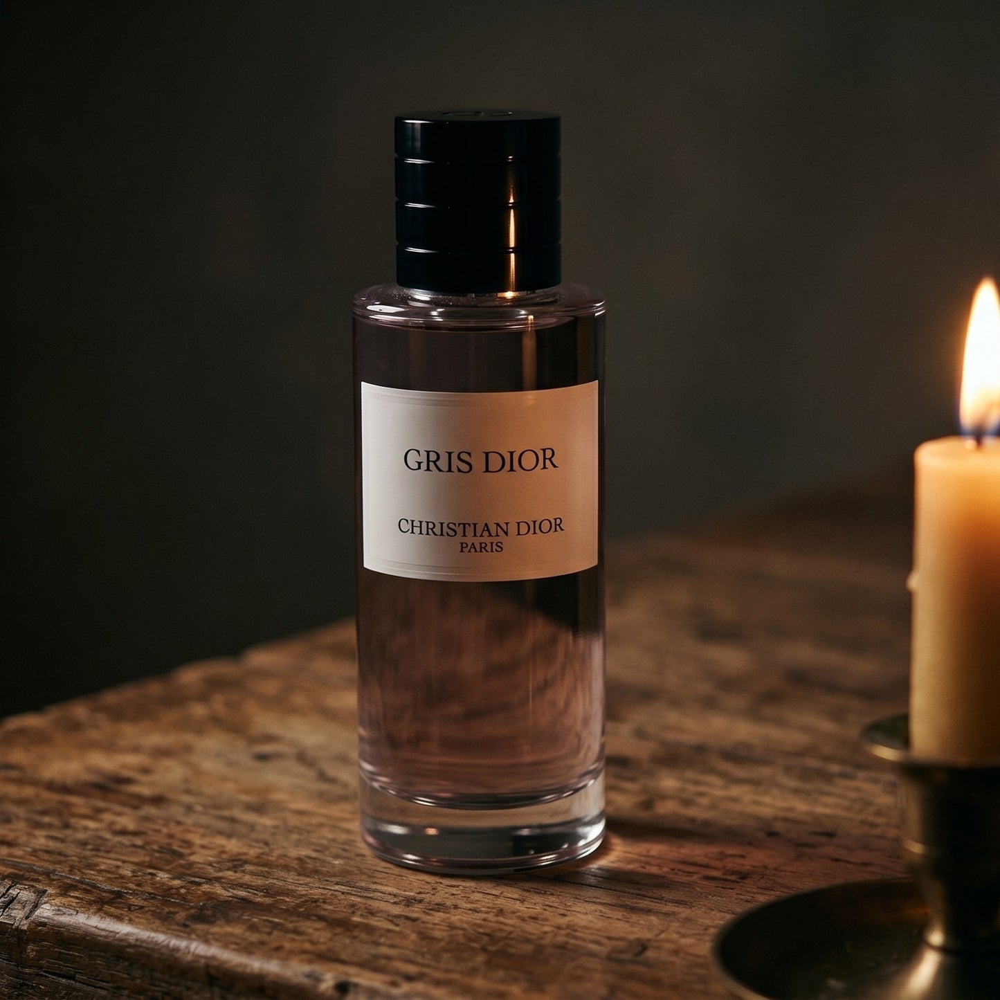 Dior Gris Dior EDP on reclaimed oak surface with a glass hurricane lamp softly glowing