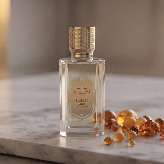 Ex Nihilo Scarlet Sands EDP - Dubai Exclusive on pale grey marble with amber resin beads scattered to one side