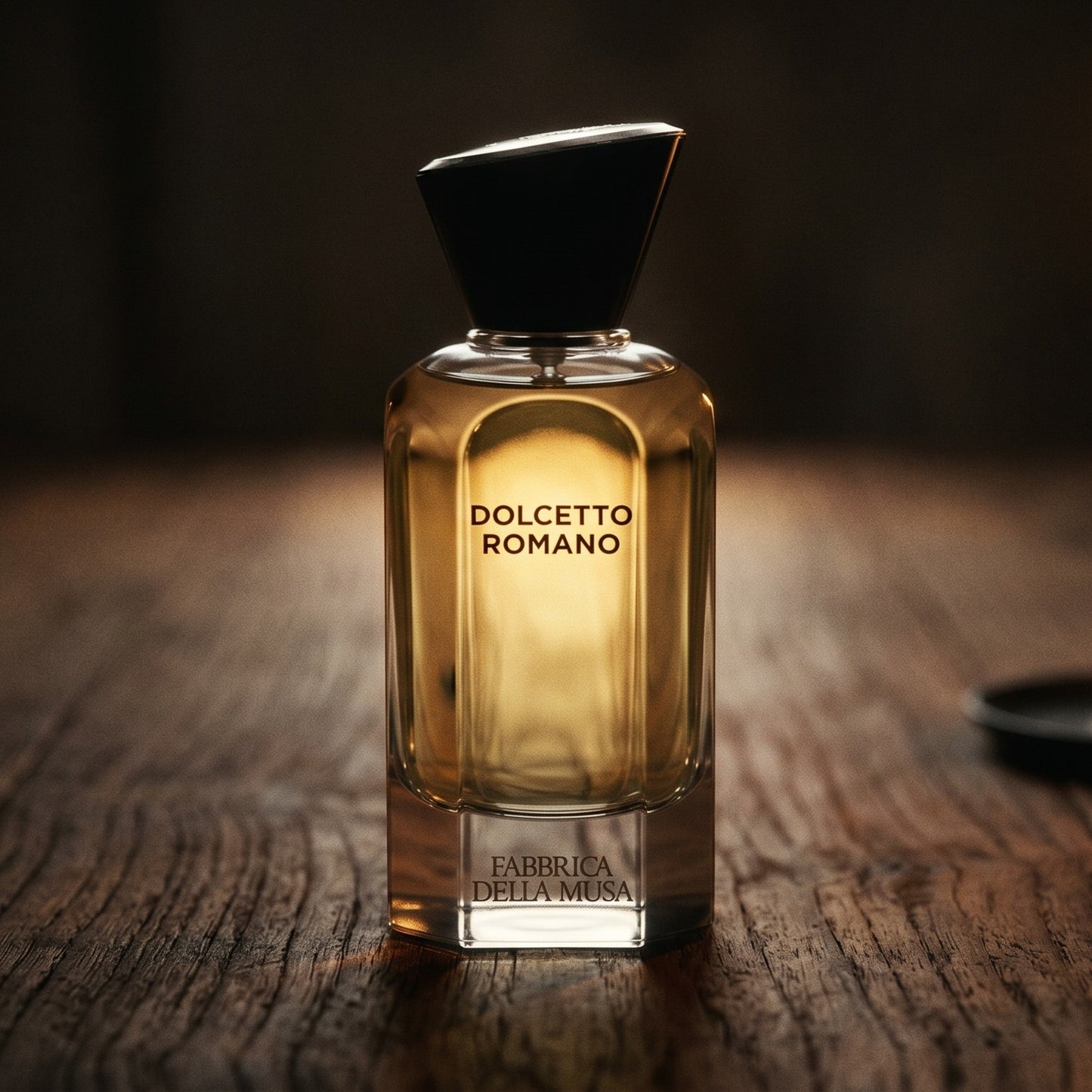 Fabbrica Della Musa Dolcetto Romano EDP on dark cherrywood with a tall beeswax taper casting warm light