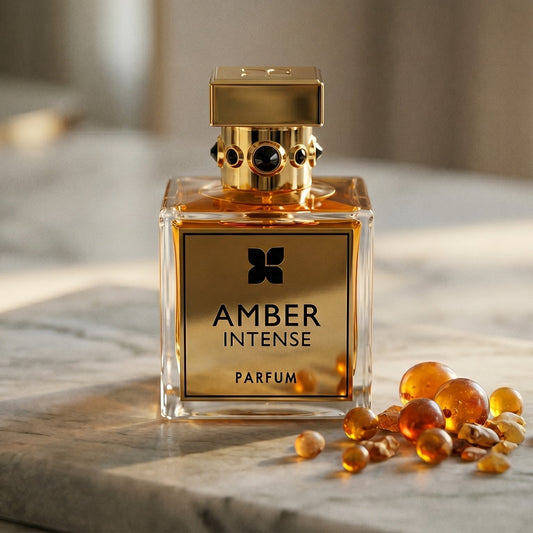 Fragrance du Bois Amber Intense EDP on pale sandstone with golden amber shards catching the light