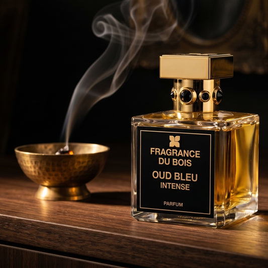 Fragrance Du Bois Oud Bleu Intense on charcoal slate with a slender oud chip and drifting incense smoke
