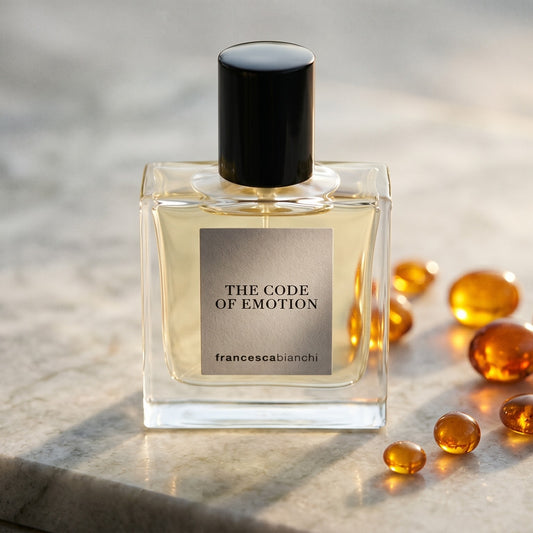Francesca Bianchi The Code Emotion Extrait de Parfume on polished limestone with benzoin resin pebbles arranged loosely