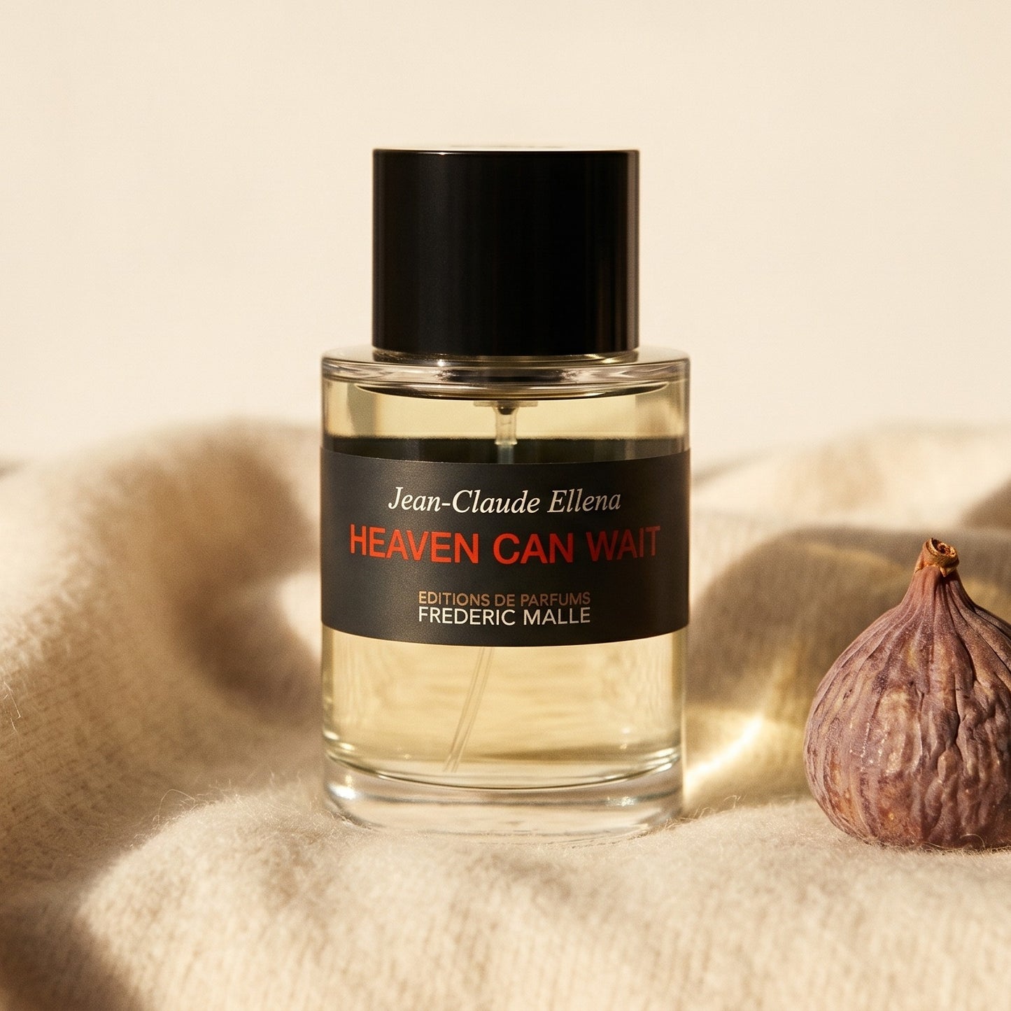Frederic Malle Heaven Can Wait EDP on beige wool with a halved dried date and a few almonds