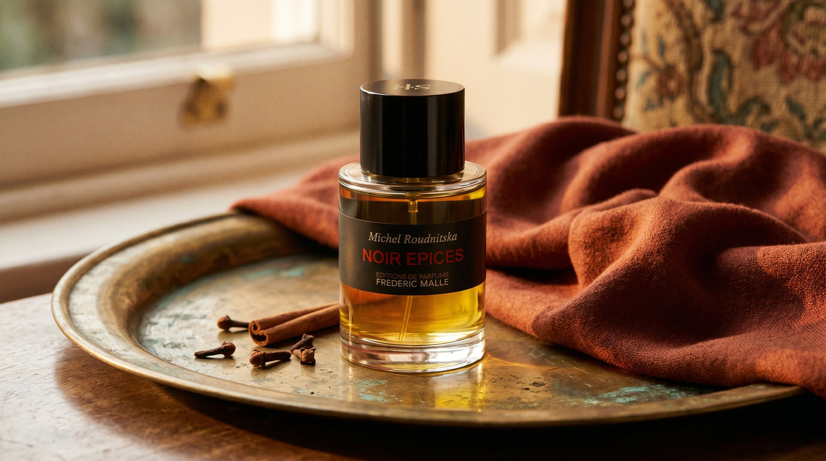Frederic Malle Noir Epices EDP on aged brass tray with a folded pashmina in rust tone