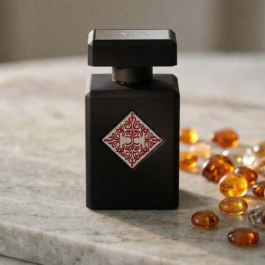 Initio Absolute Aphrodisiac EDP on polished limestone with benzoin resin pebbles arranged loosely