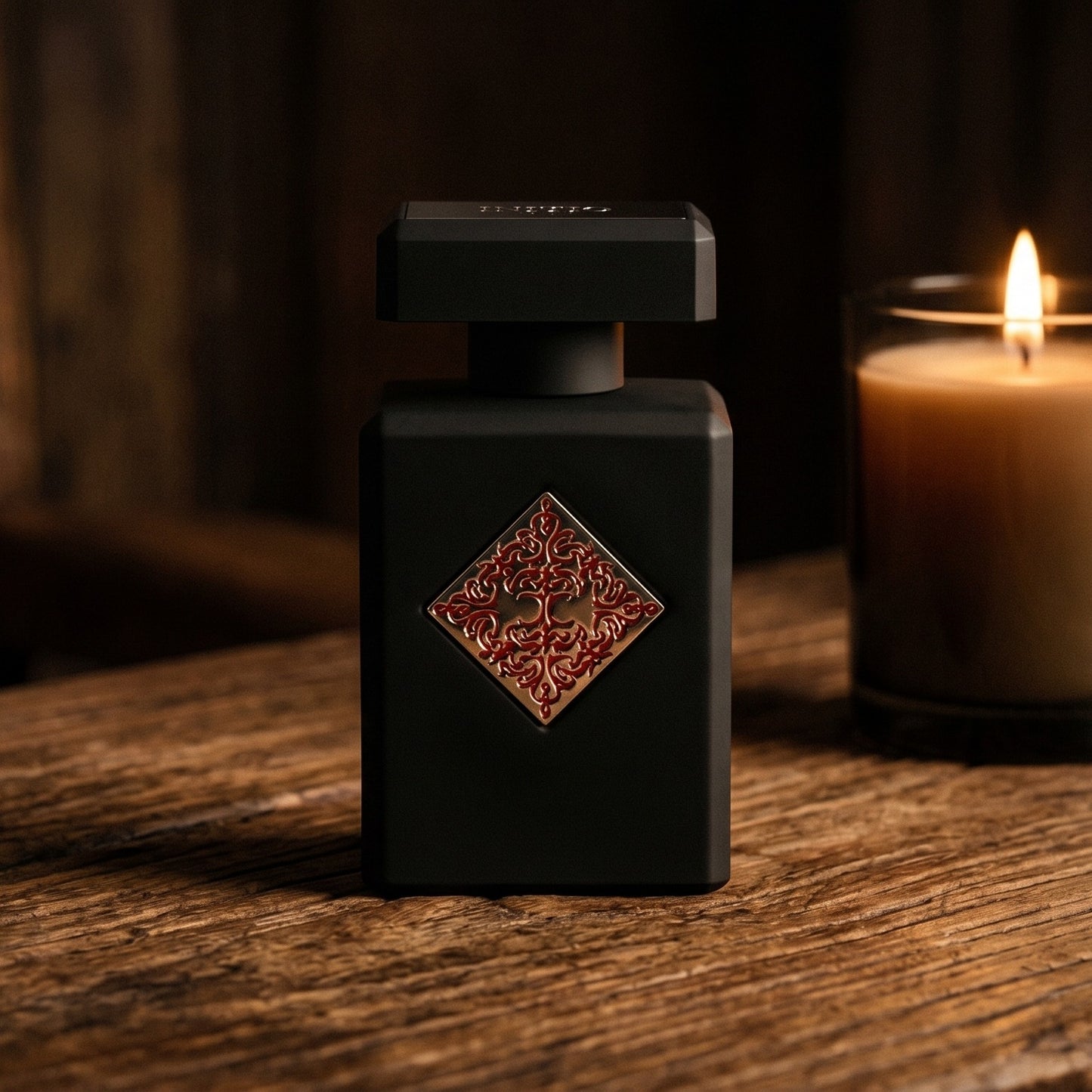 Initio Divine Attraction EDP on aged teak with a candle burning gently to frame-right