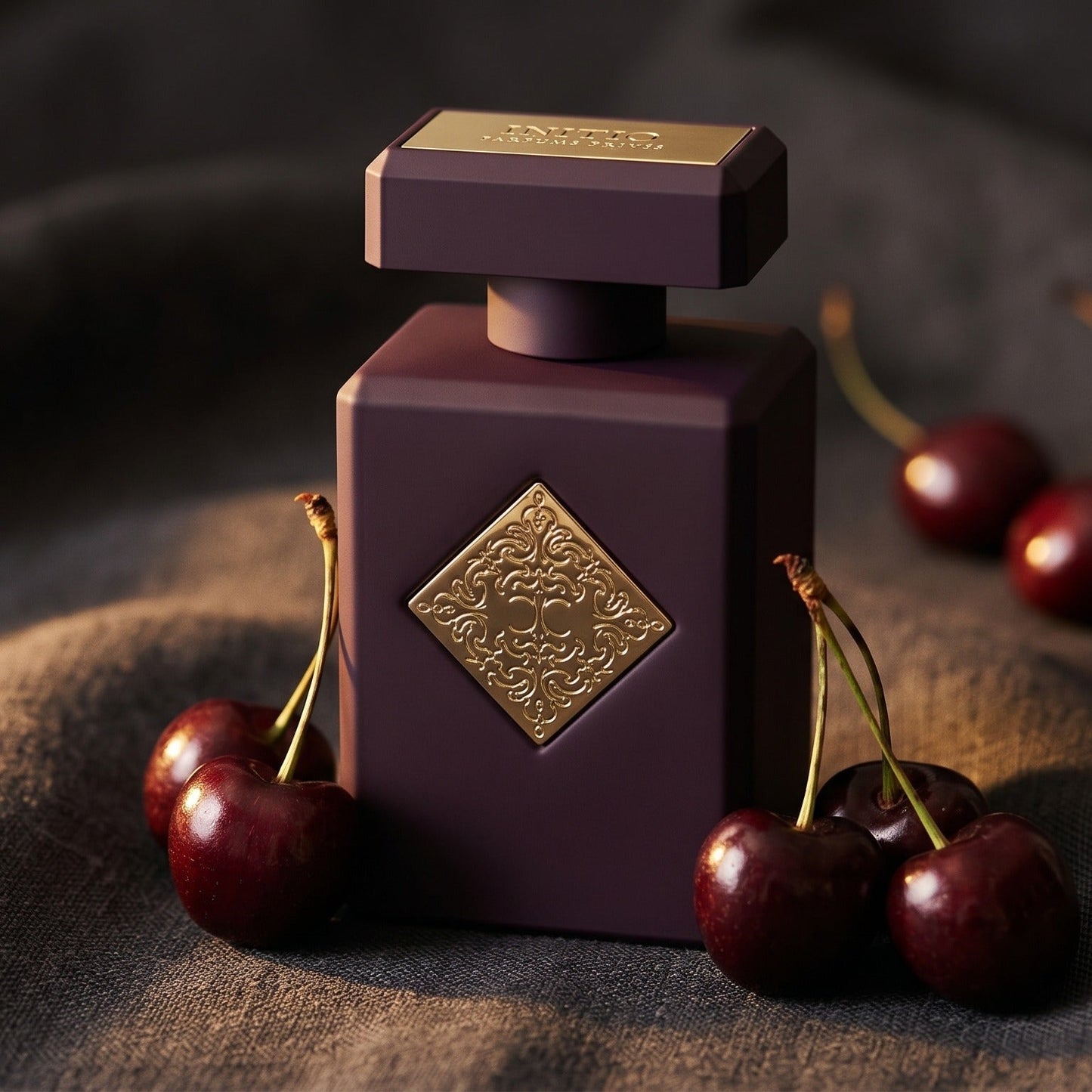 Initio Narcotic Delight EDP on charcoal linen with fresh cherries