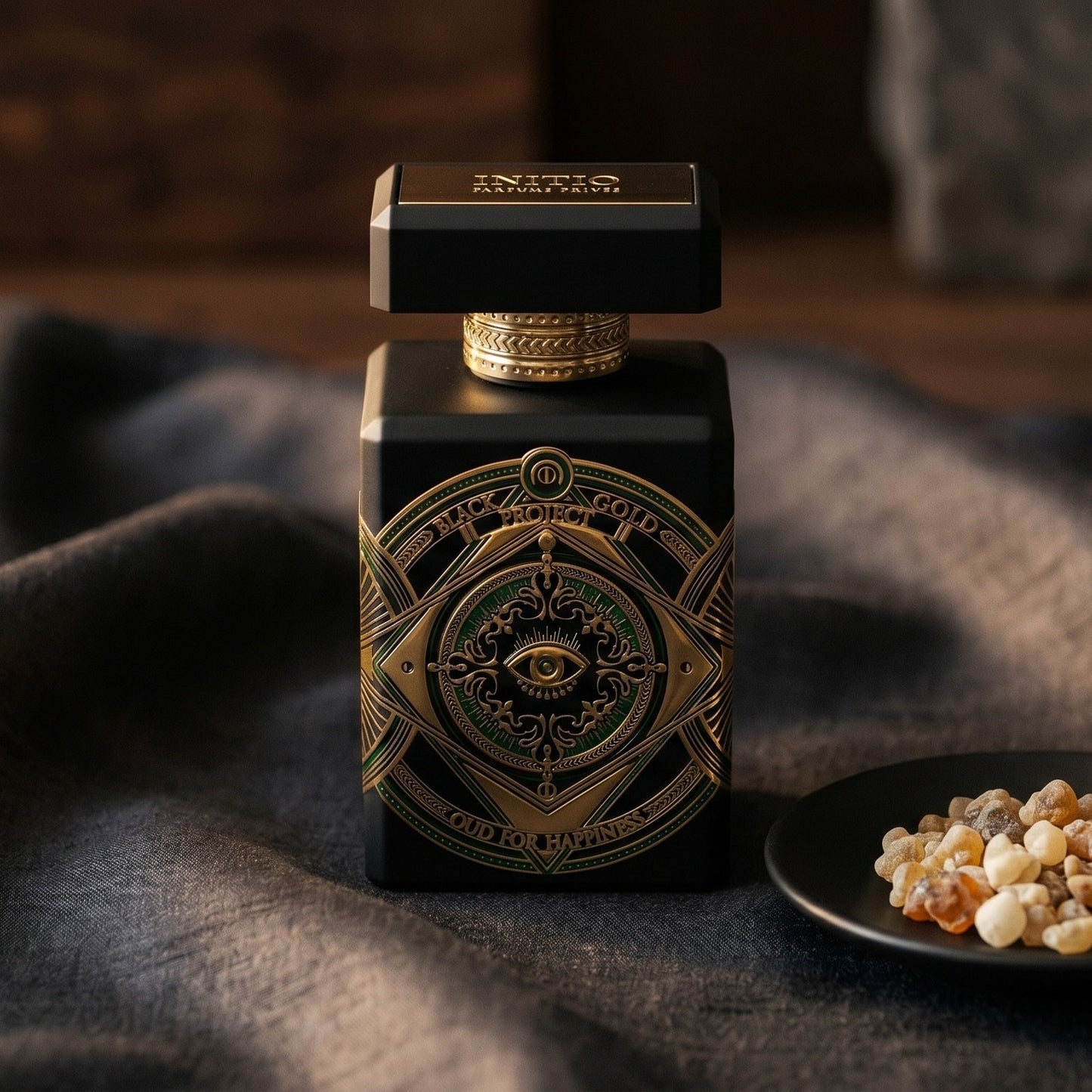 Initio Oud for Happiness on onyx linen with dried rose petals and resin drops intermixed