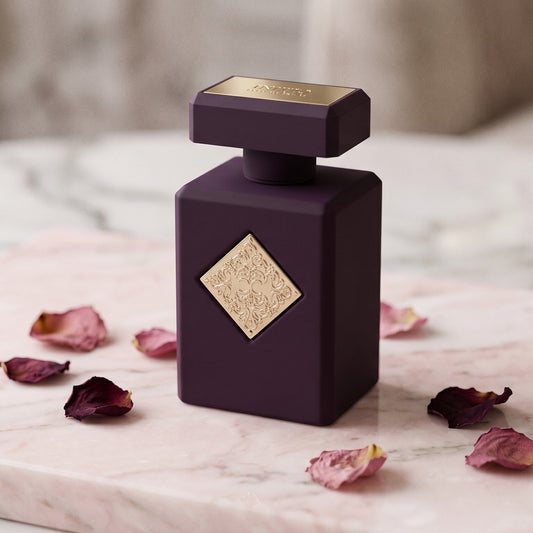 Initio Psychedelic Love EDP on champagne-pink stone with tea-rose petals in soft clusters