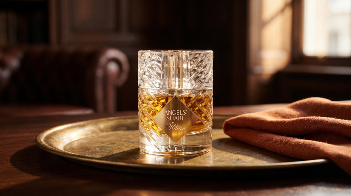 Kilian Angels Share EDP on aged brass tray with a folded pashmina in rust tone