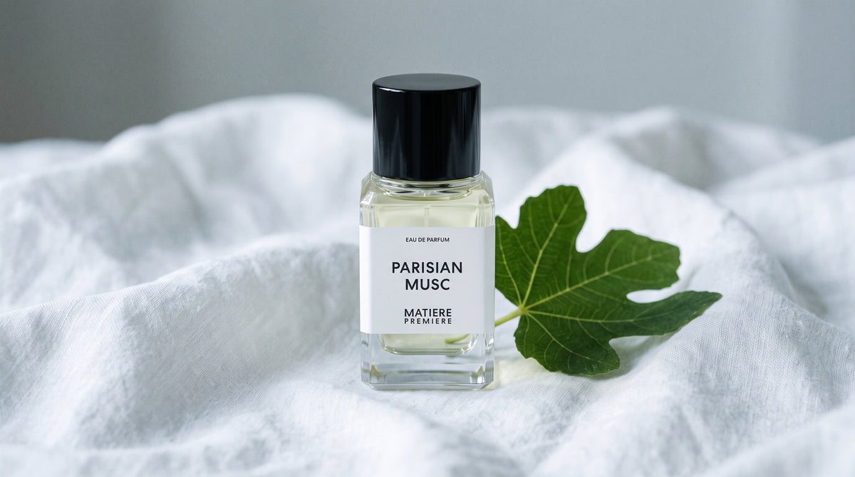 Matiere Premiere Parisian Musc EDP on white linen with a single fresh fig leaf