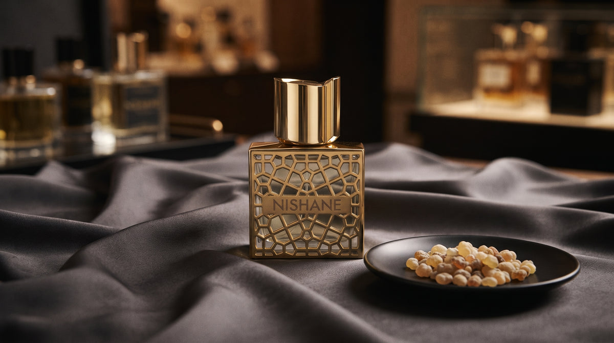 Nishane Hacivat Oud Extrait de Parfum on charcoal silk with frankincense resin granules in a small saucer