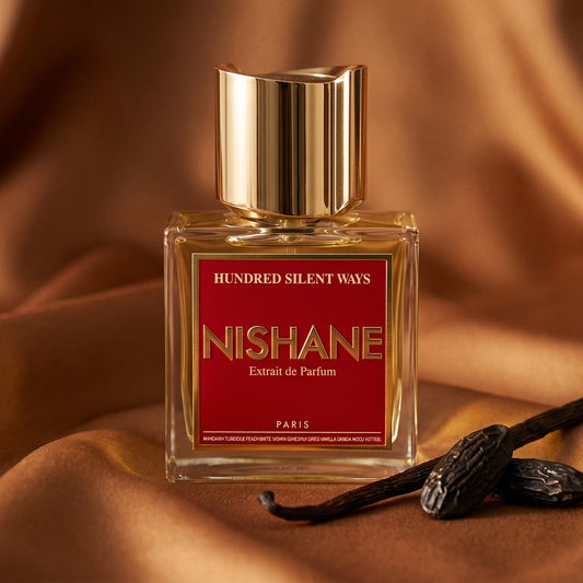 Nishane Hundred Silent Ways EDP on amber satin with a spiral of dried orange peel and vanilla