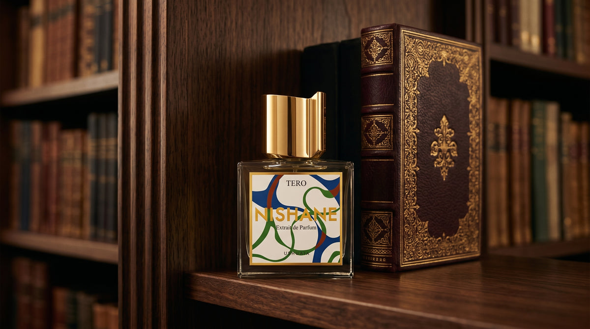 Nishane Tero EDP on dark walnut library shelf with a leather-bound book with gold foil