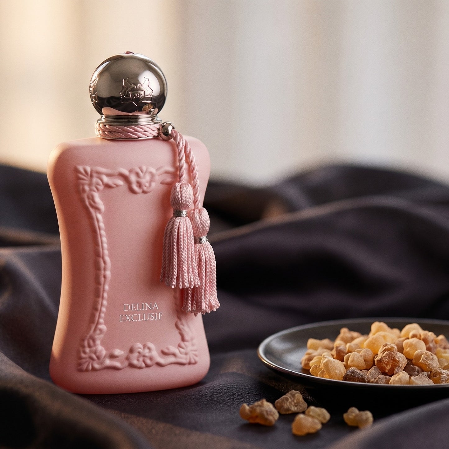 Parfums de Marly Delina Exclusif Parfum on charcoal silk with frankincense resin granules in a small saucer
