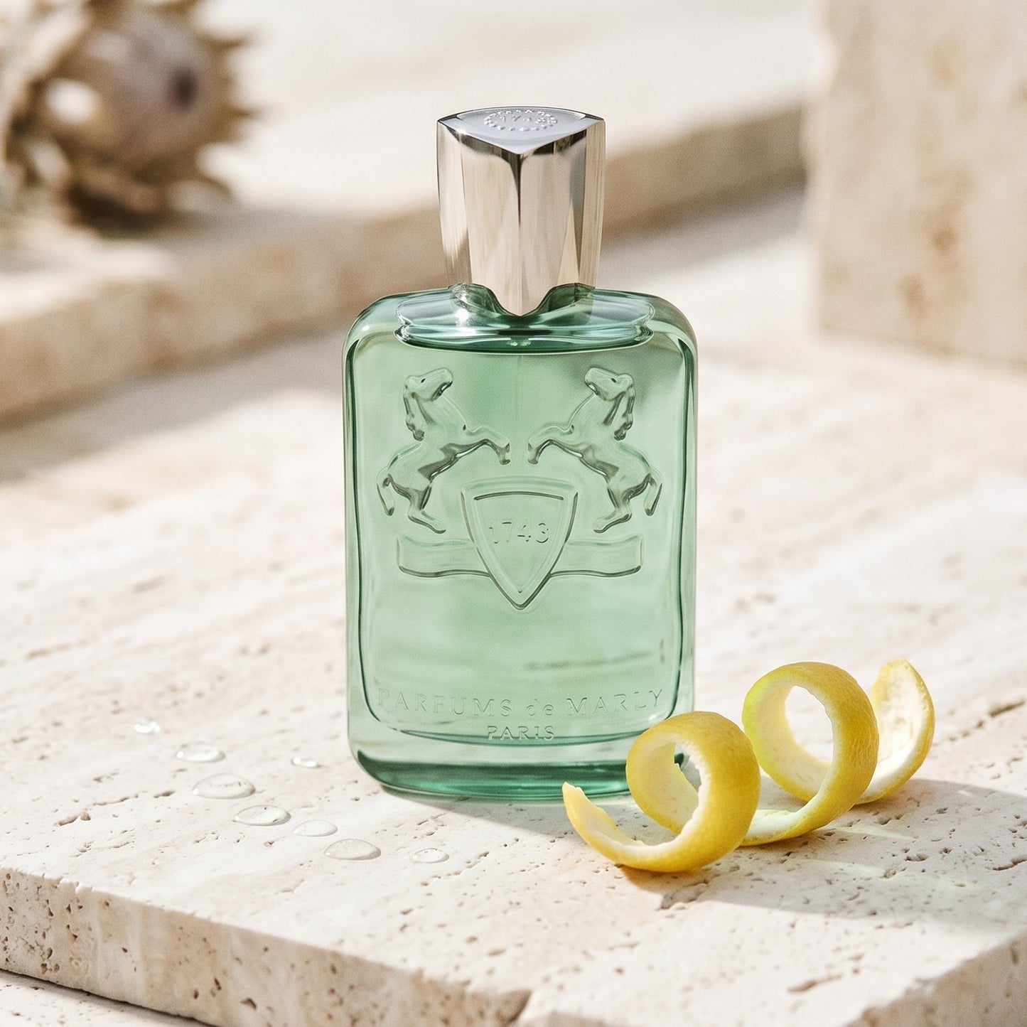Parfums de Marly Greenley on bleached limestone with a mandarin peel fanned outward