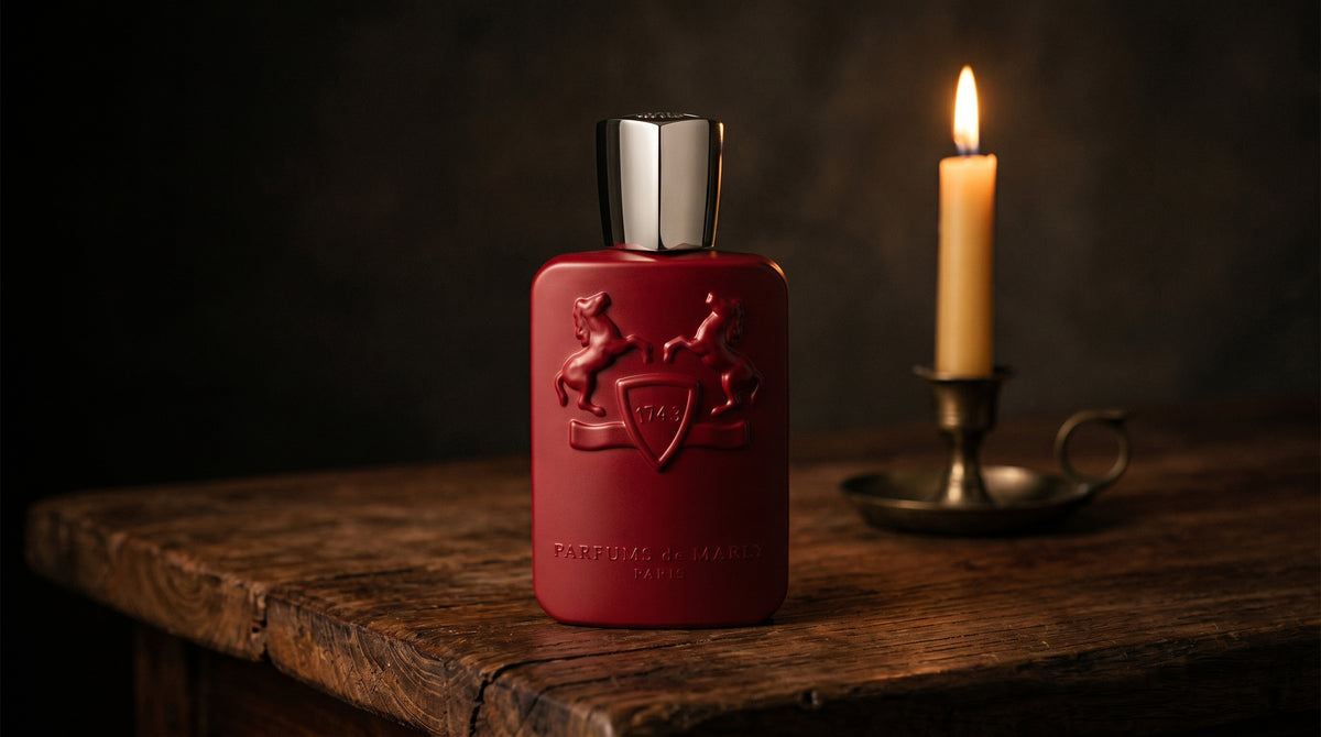 Parfums de Marly Kalan EDP on aged teak with a candle burning gently to frame-right