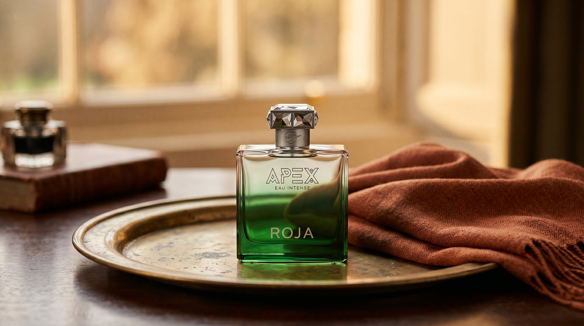 Roja Apex Eau Intense EDP on aged brass tray with a folded pashmina in rust tone