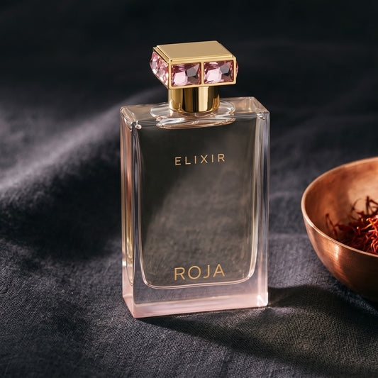 Roja Elixir Pour Femme EDP on charcoal canvas with a scatter of dried cloves and cinnamon shards