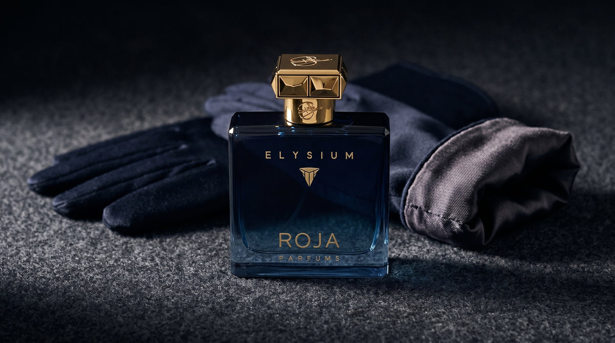 Roja Elysium Parfum EDP on charcoal felt with a silk-lined glove just behind the bottle