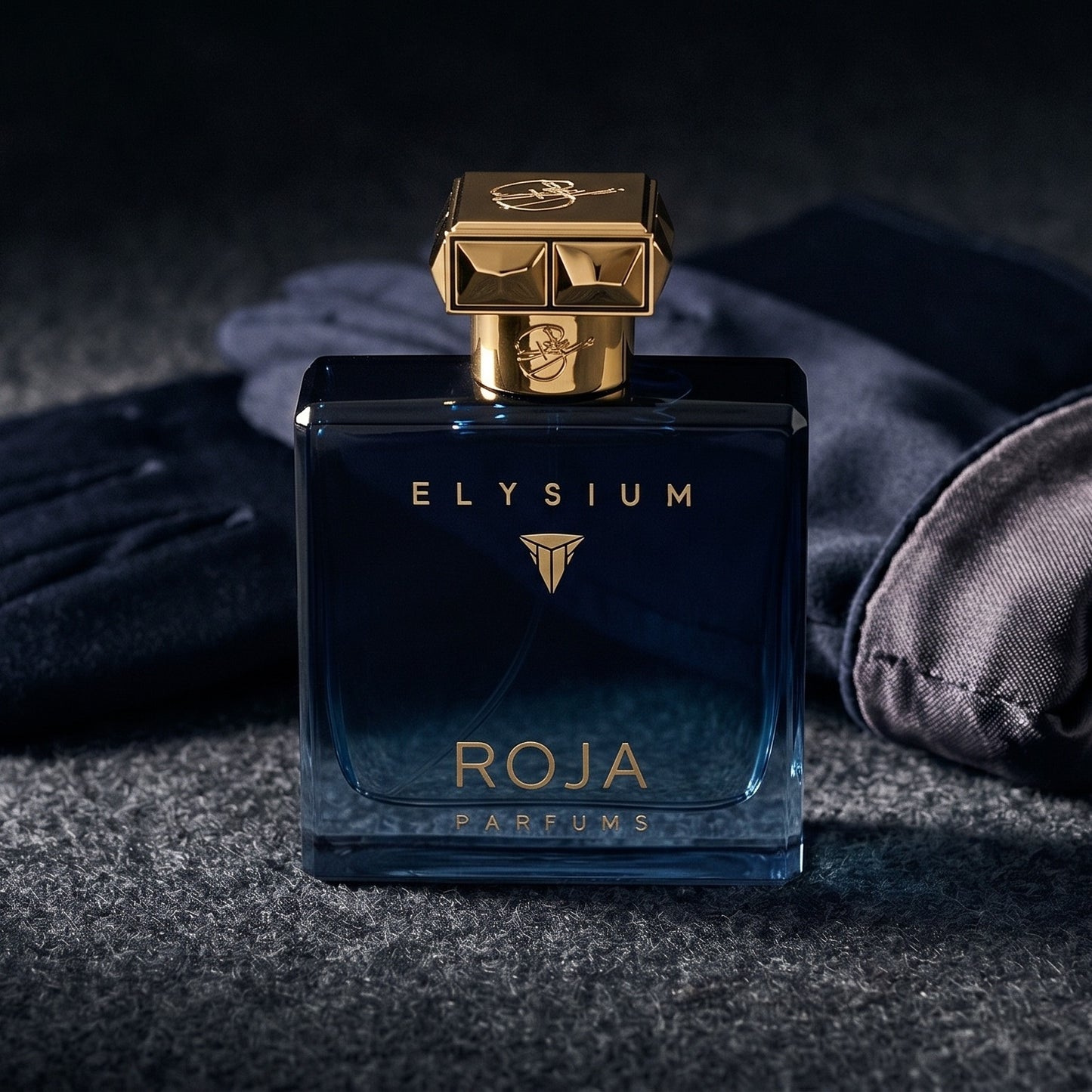 Roja Elysium Parfum EDP on smoke-grey wool with a folded pair of driving gloves to the side
