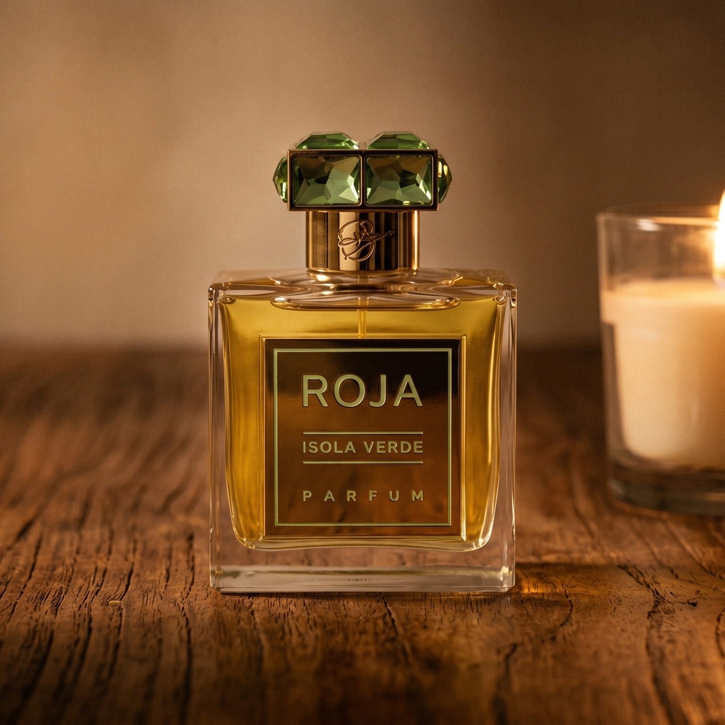 Roja Isola Verde Parfum on walnut side table with a pair of lit votives beside the bottle