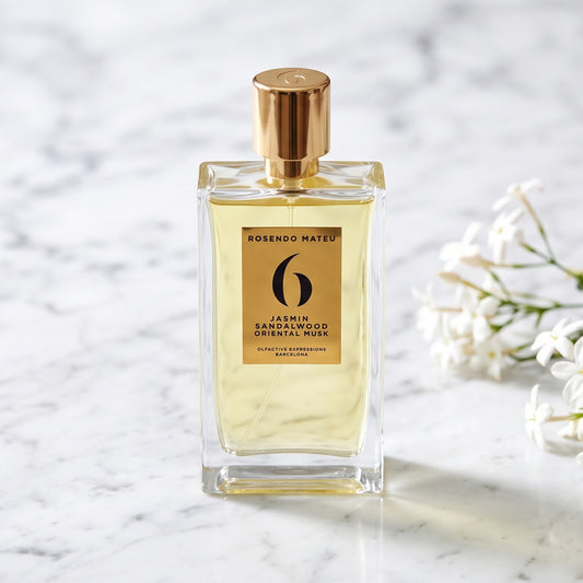 Rosendo Mateu No. 6 EDP on white carrara marble with jasmine sambac sprigs placed to frame-right