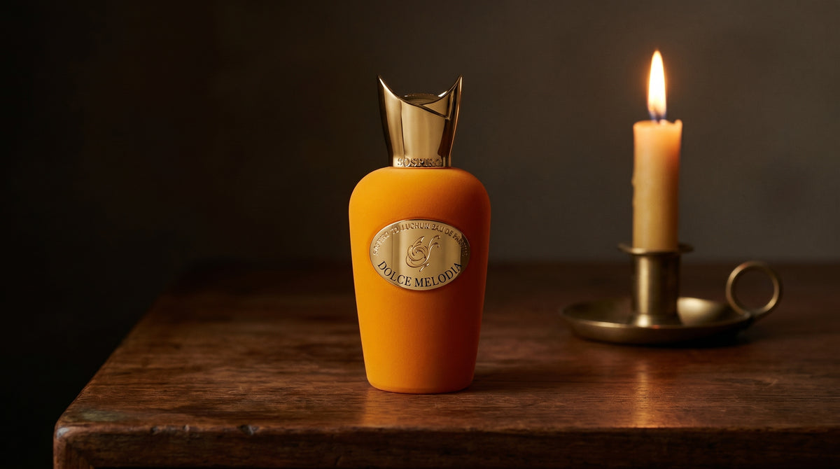 Sospiro Dolce Melodia EDP on aged teak with a candle burning gently to frame-right