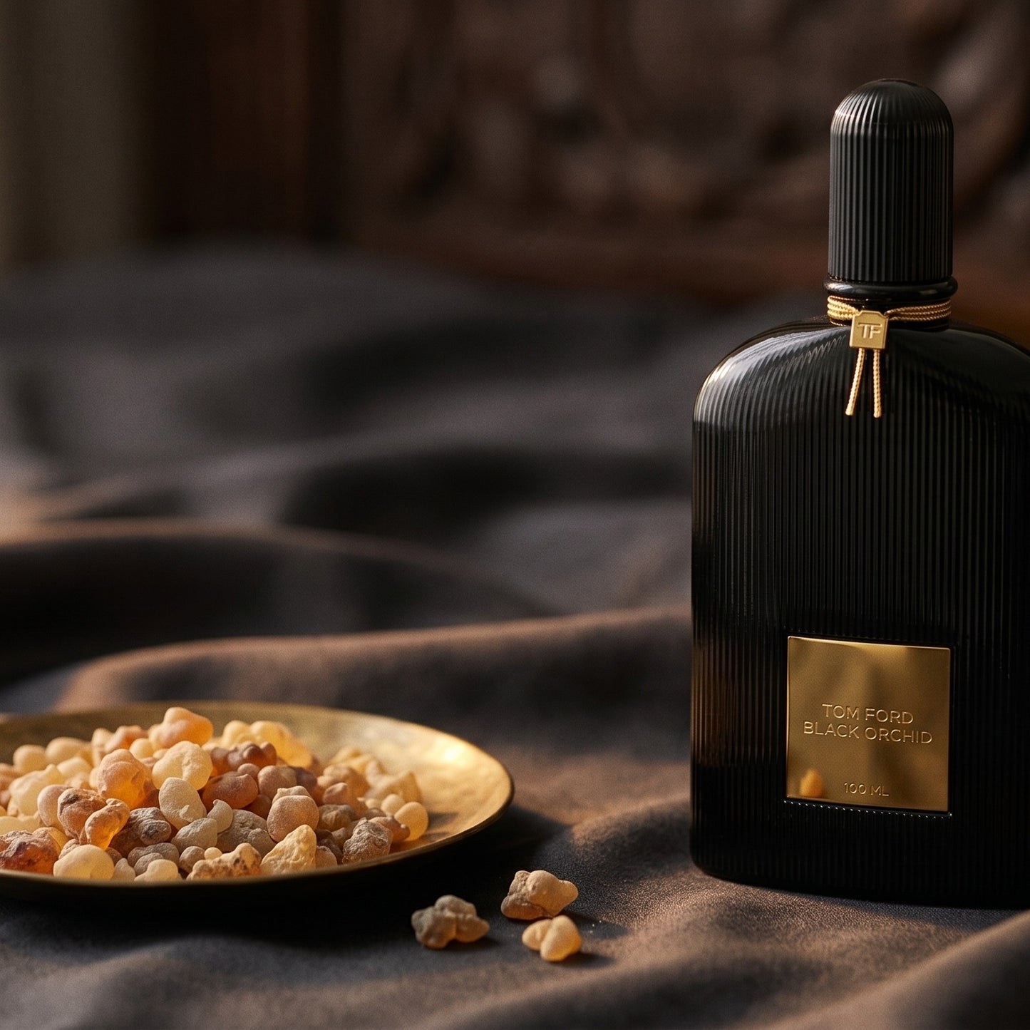 Tom Ford Black Orchid on charcoal silk with frankincense resin granules in a small saucer